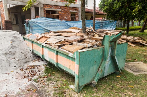Vans and crew preparing for house clearance on a Kensington street